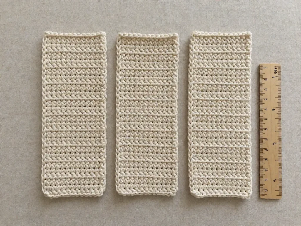 A crocheted piece showing one, two and three chain turning chains side by side at the end of rows